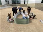 students putting together Vego beds for the garden